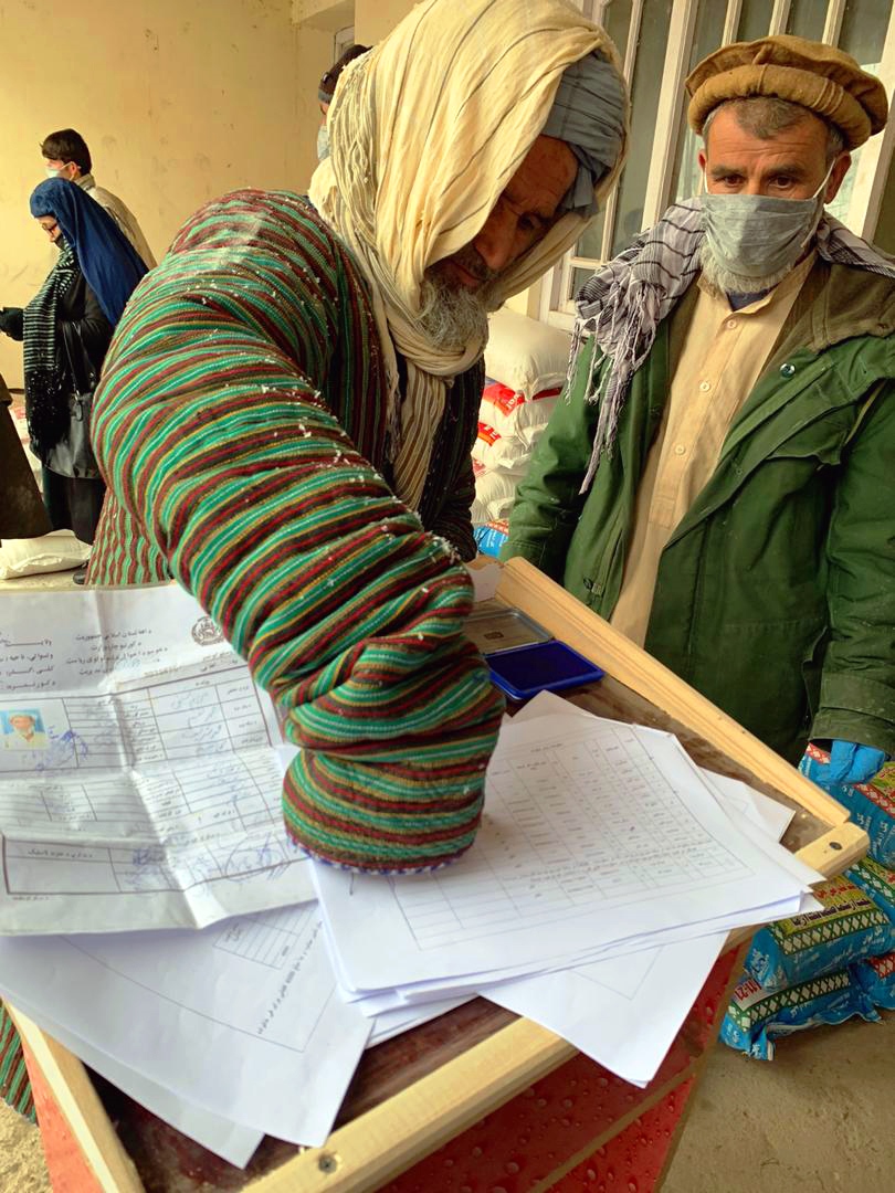 A beneficiary puts his finger print to be verified and recieve the Relief Packages in Badakhshan province